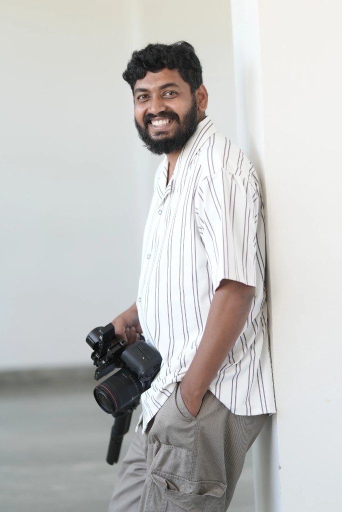 Hemanth, founder of Photomane, holding a camera
